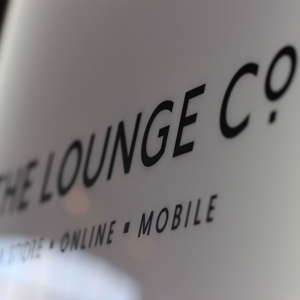 The Lounge Co in-store experience sign close-up